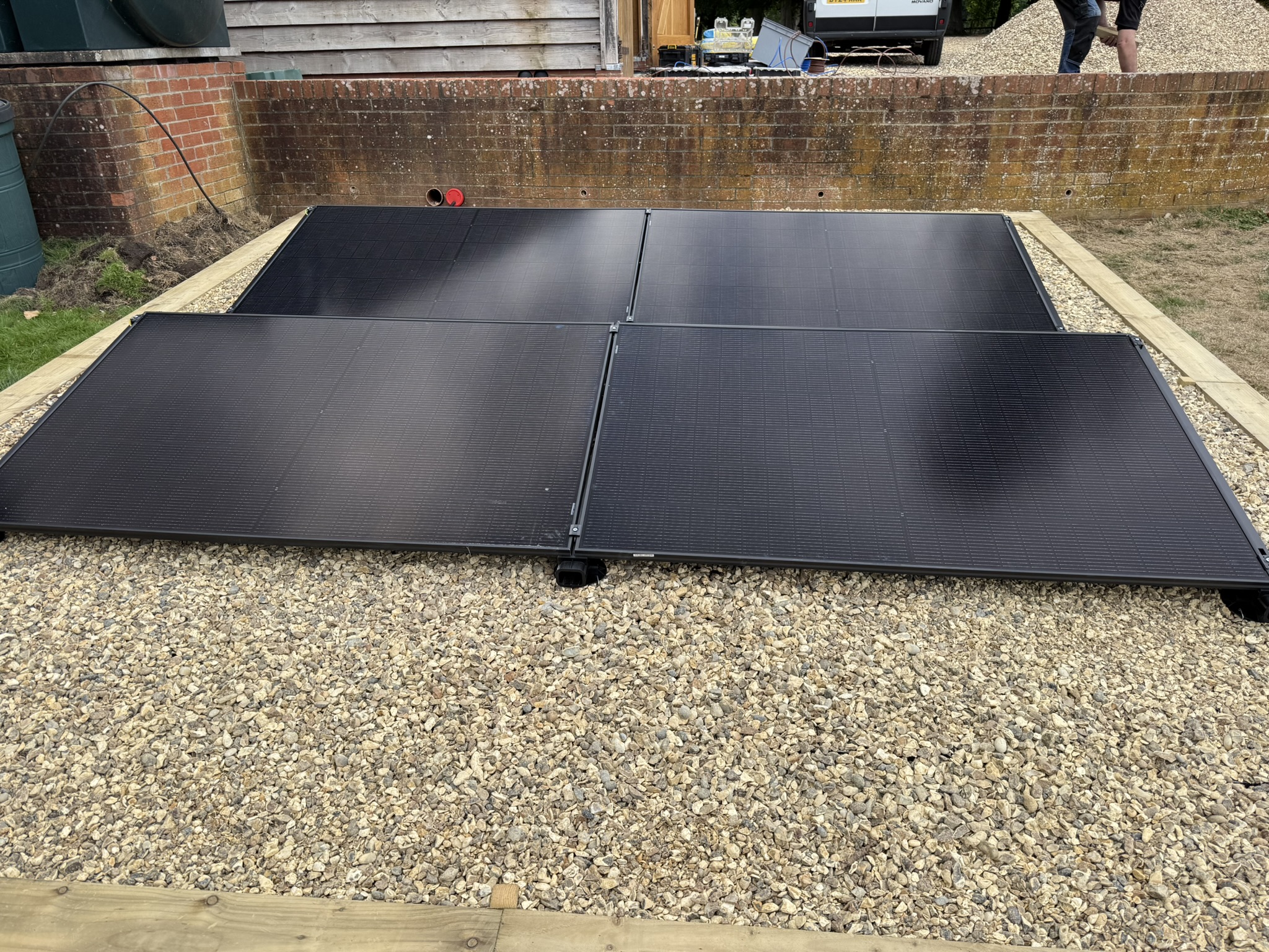 Professional solar panel installation team working on roof in Reading